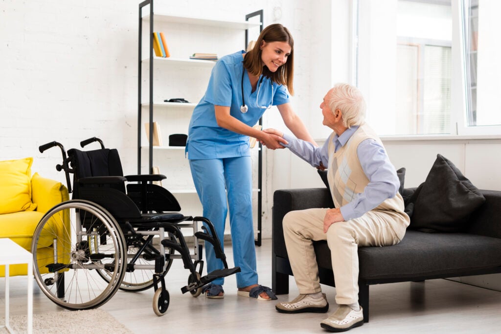 Nurse helping elderly man in Assisted living and care home accommodation 