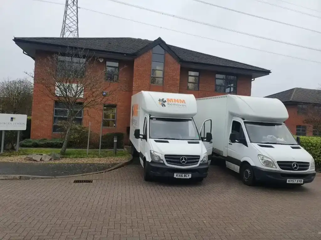 MNM Removals vans loading a large office 