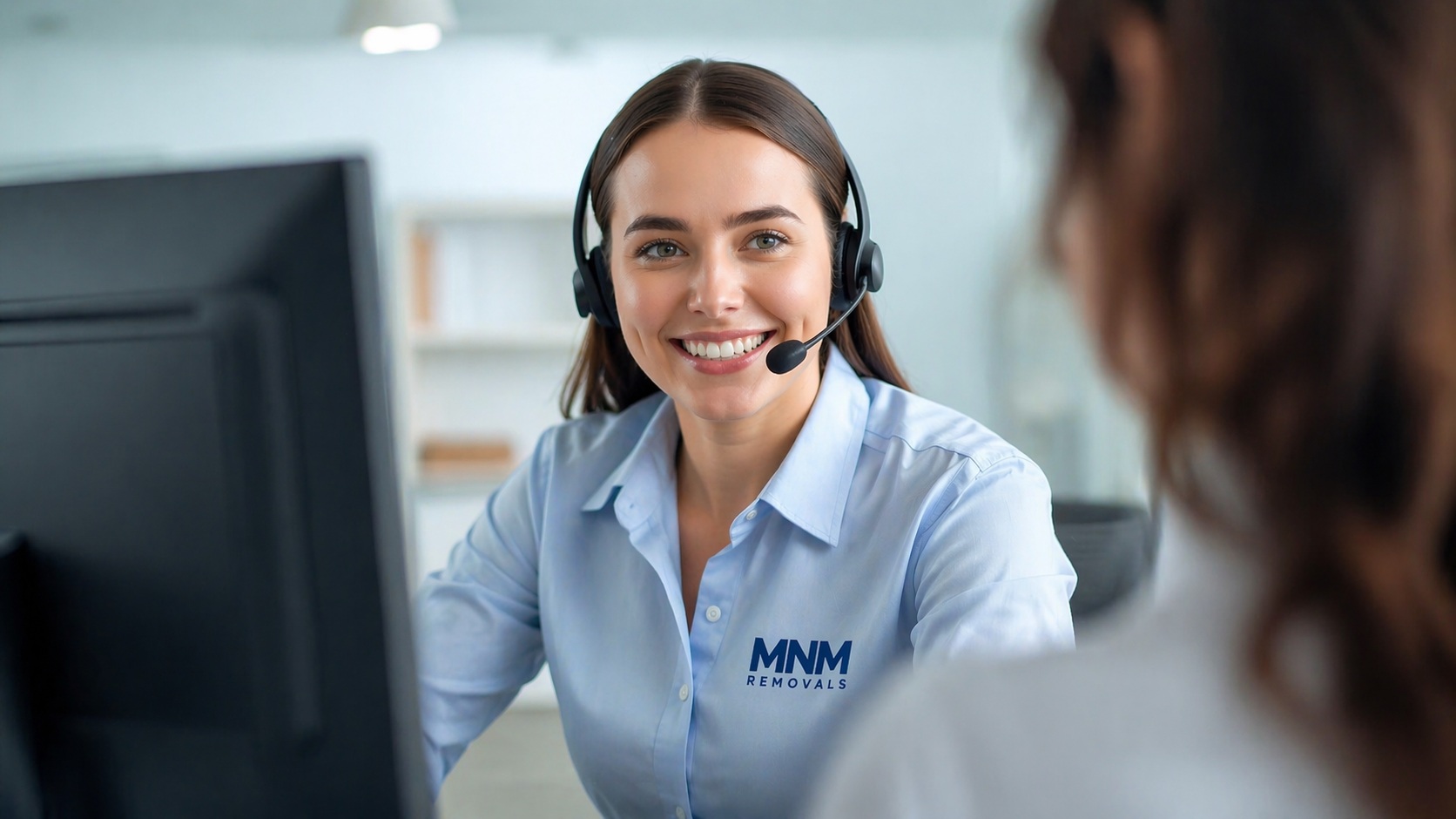 Friendly MNM Removals customer service advisor helping a customer with a house removals quote